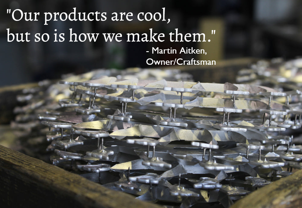 tray of freshly cast pewter sits in the workshop with a quote on the image "our products are cool, but so is how we make them" martin aitken fredericton pewter