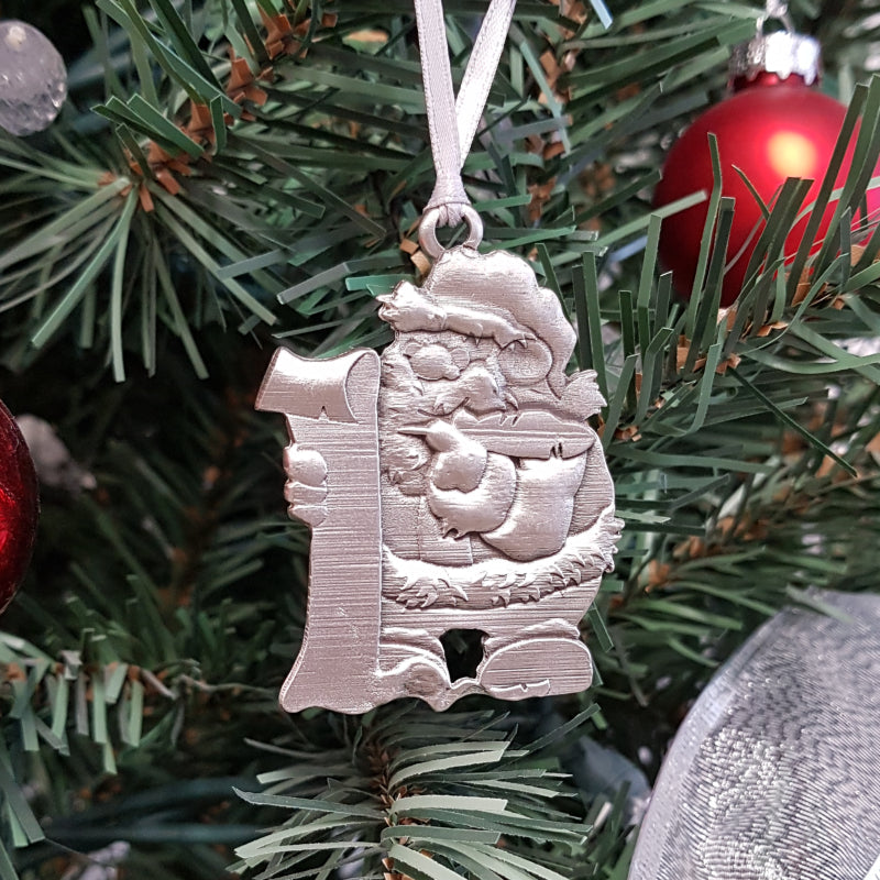 pewter santa claus ornament on christmas tree