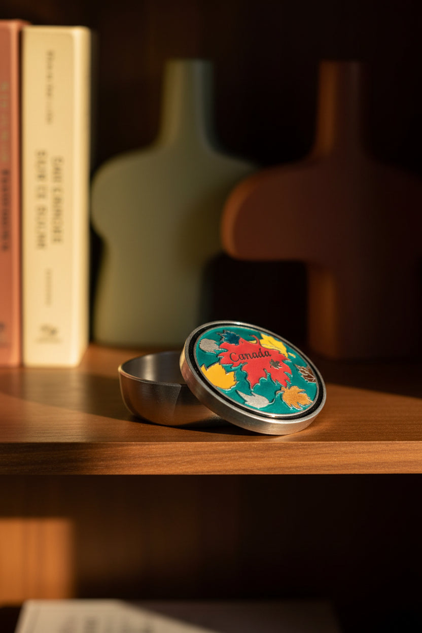 Metallic ball marker with Canadian design on a white background