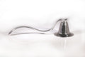 Pewter candle snuffer with a long curved handle
