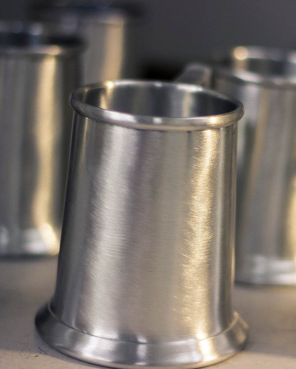 Metal cups with a reflective surface on a dark background