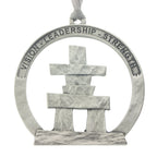 An Inukshuk on a circular cut out. Christmas Tree ornament. Made from Pewter. Silver ribbon. Made in Fredericton NB New Brunswick Canada