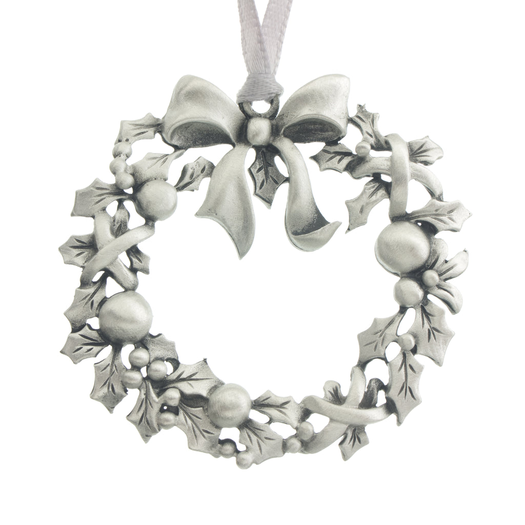 A Holiday wreath fashioned from Holly. Christmas Tree ornament. Made from Pewter. Silver ribbon. Made in Fredericton NB New Brunswick Canada